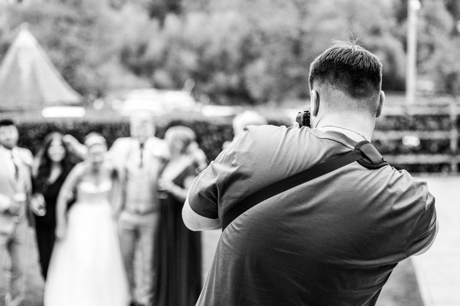 Alex Ellison photographing a bride and groom on their wedding day