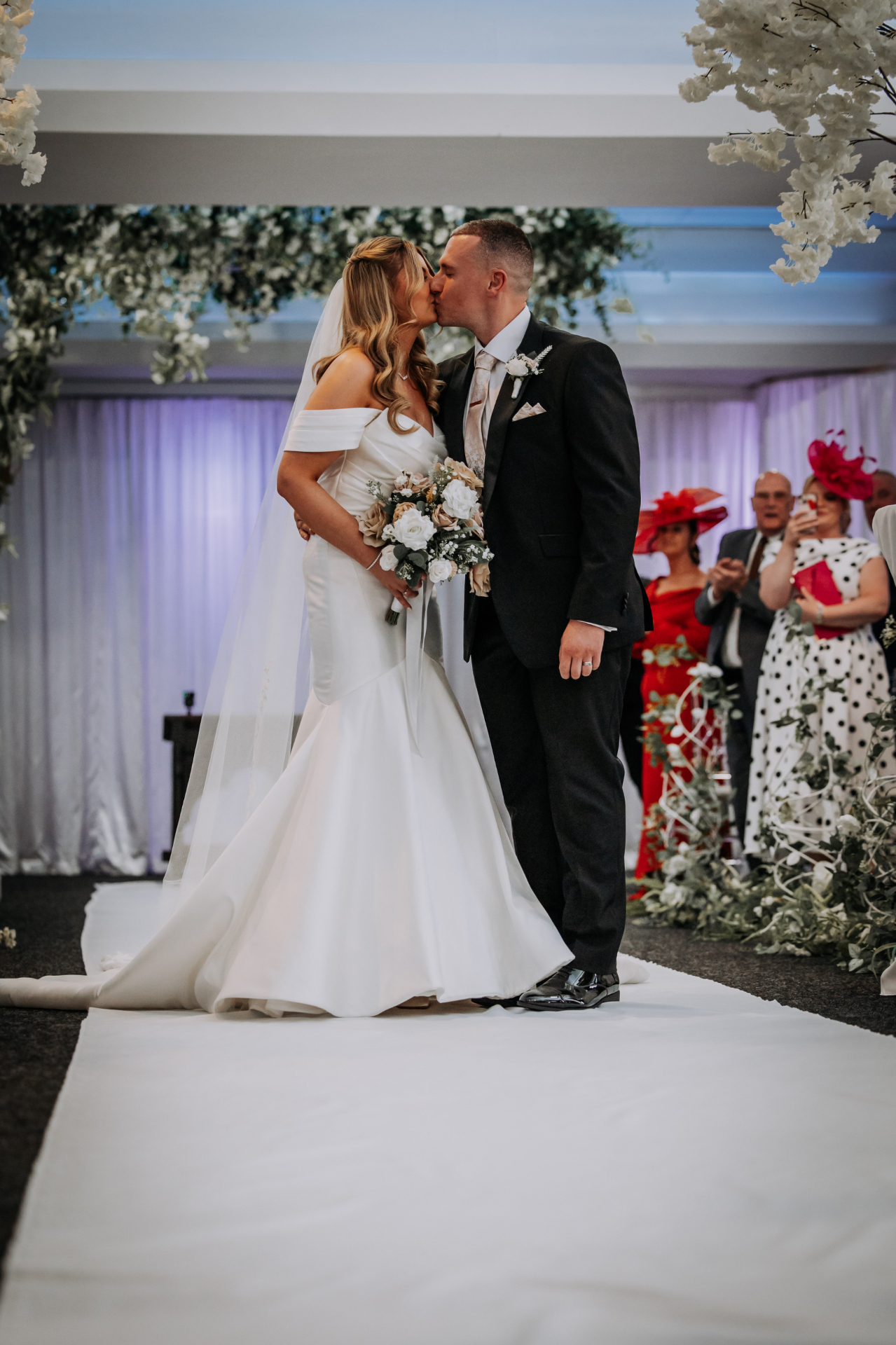 First kiss at the end of the aisle