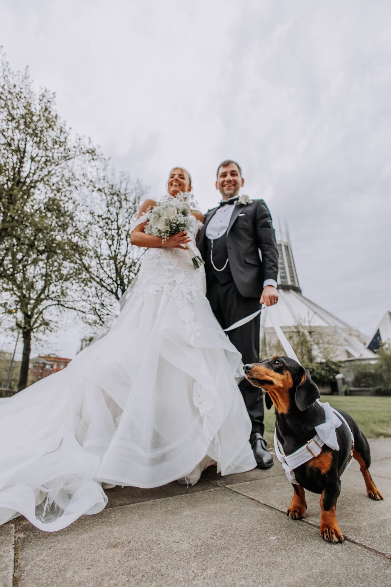 Couple with their sausage dog outside the cathedral