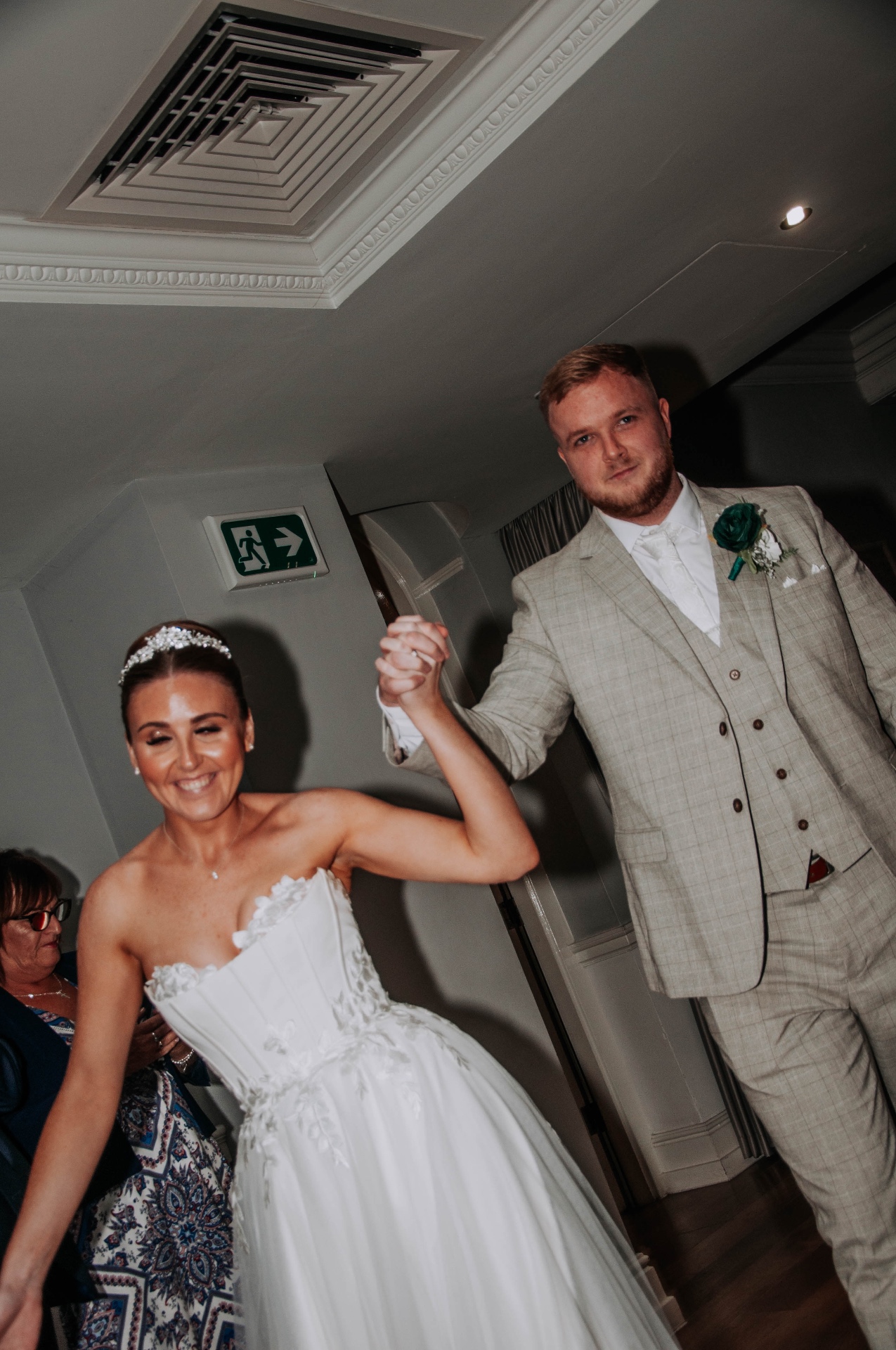 Newlyweds entering the reception hand in hand