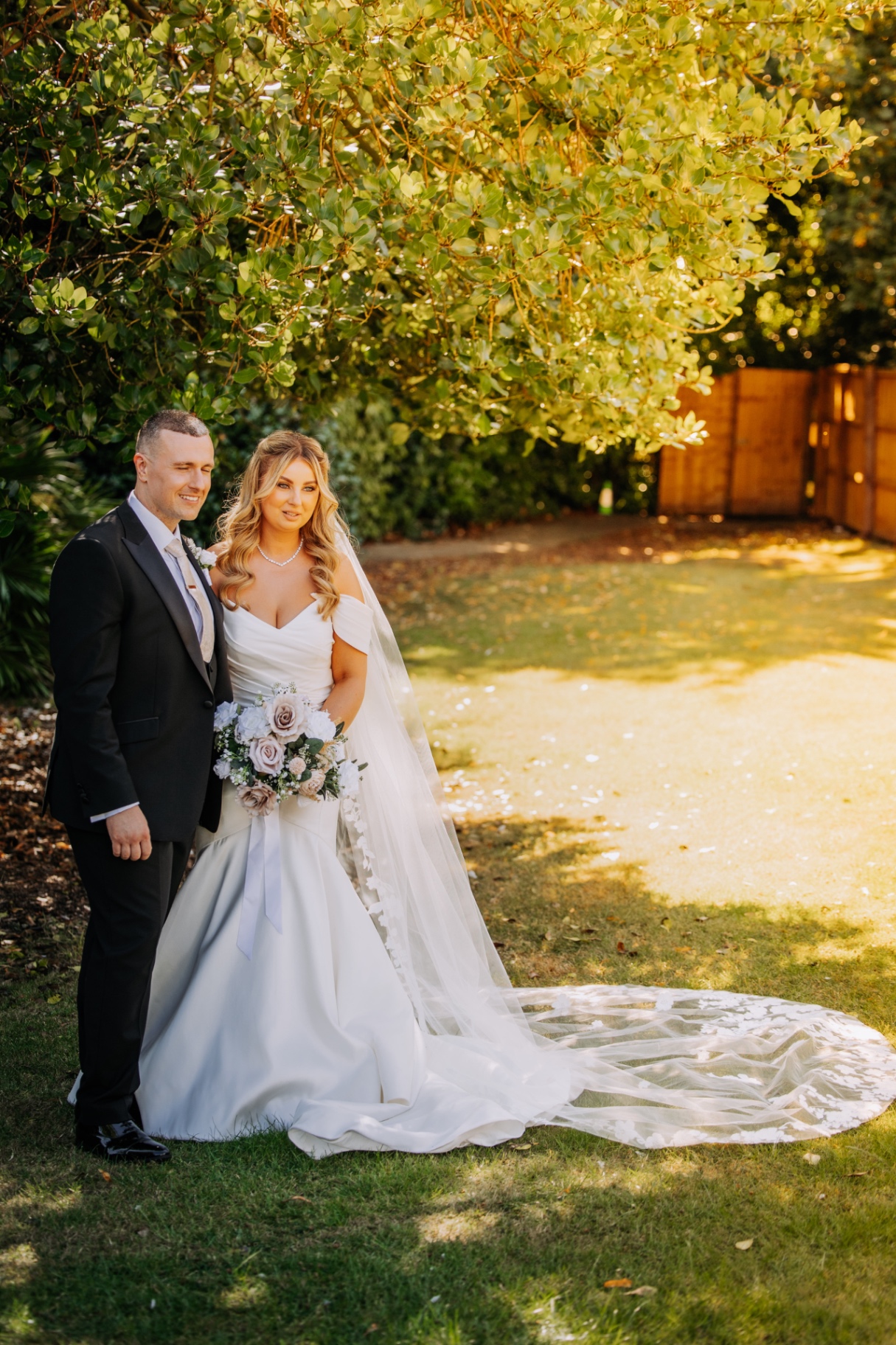 Couple in golden evening light under the trees